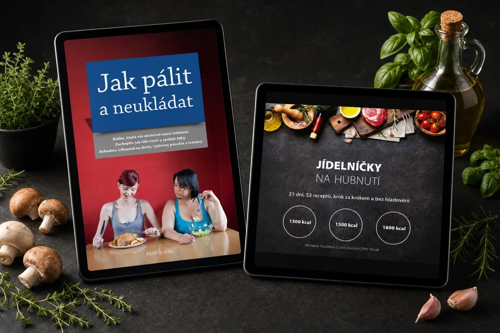 Dva tablety s obálkami knih Jak pálit a neukládat a Jídelníčky na hubnutí, studiový snímek na tmavé desce